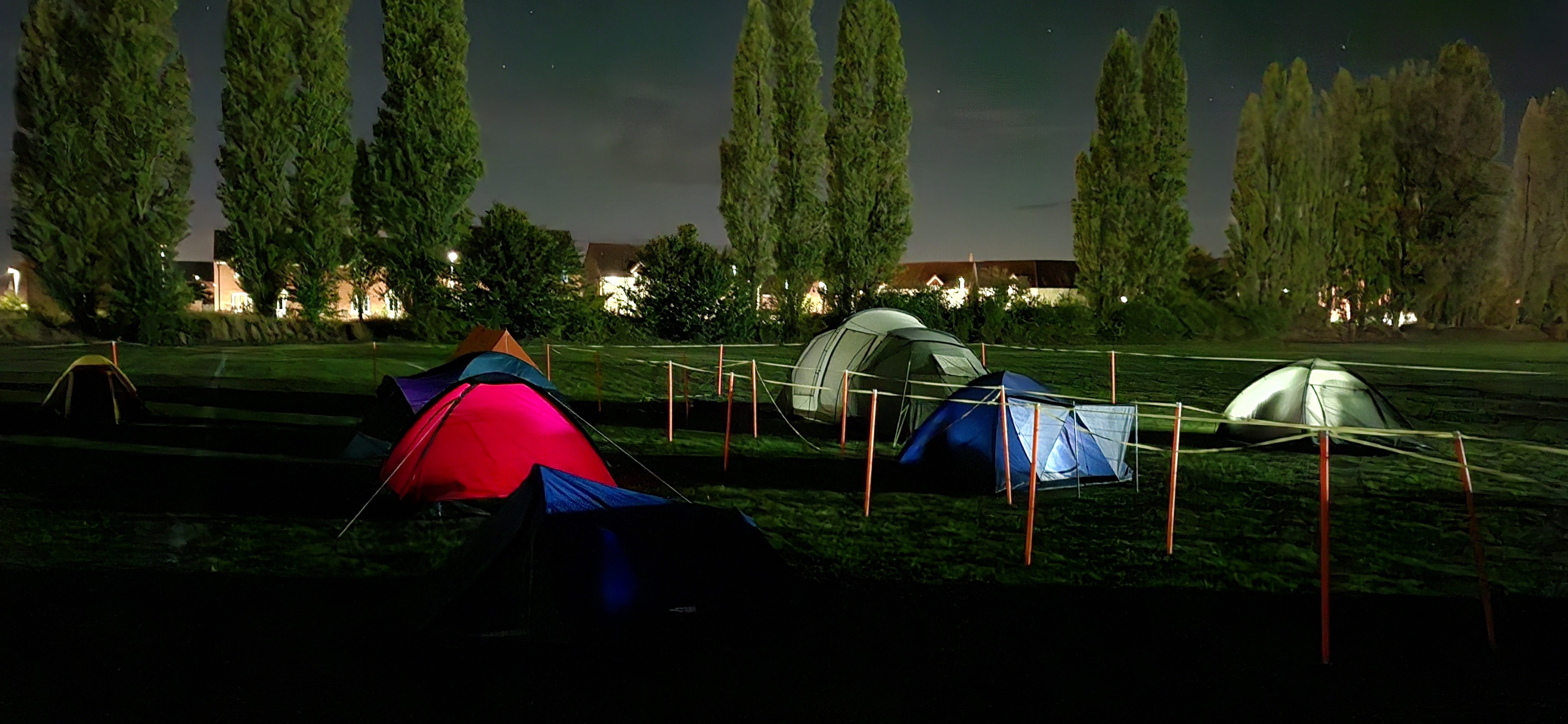 UPS student camping out in the dark at the Peter Paine Centre - three tents in the image