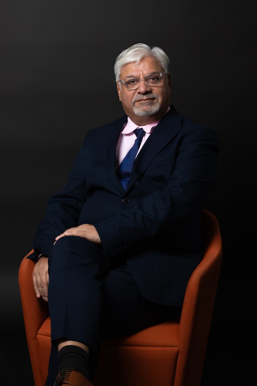 A headshot of Abid Hussain.