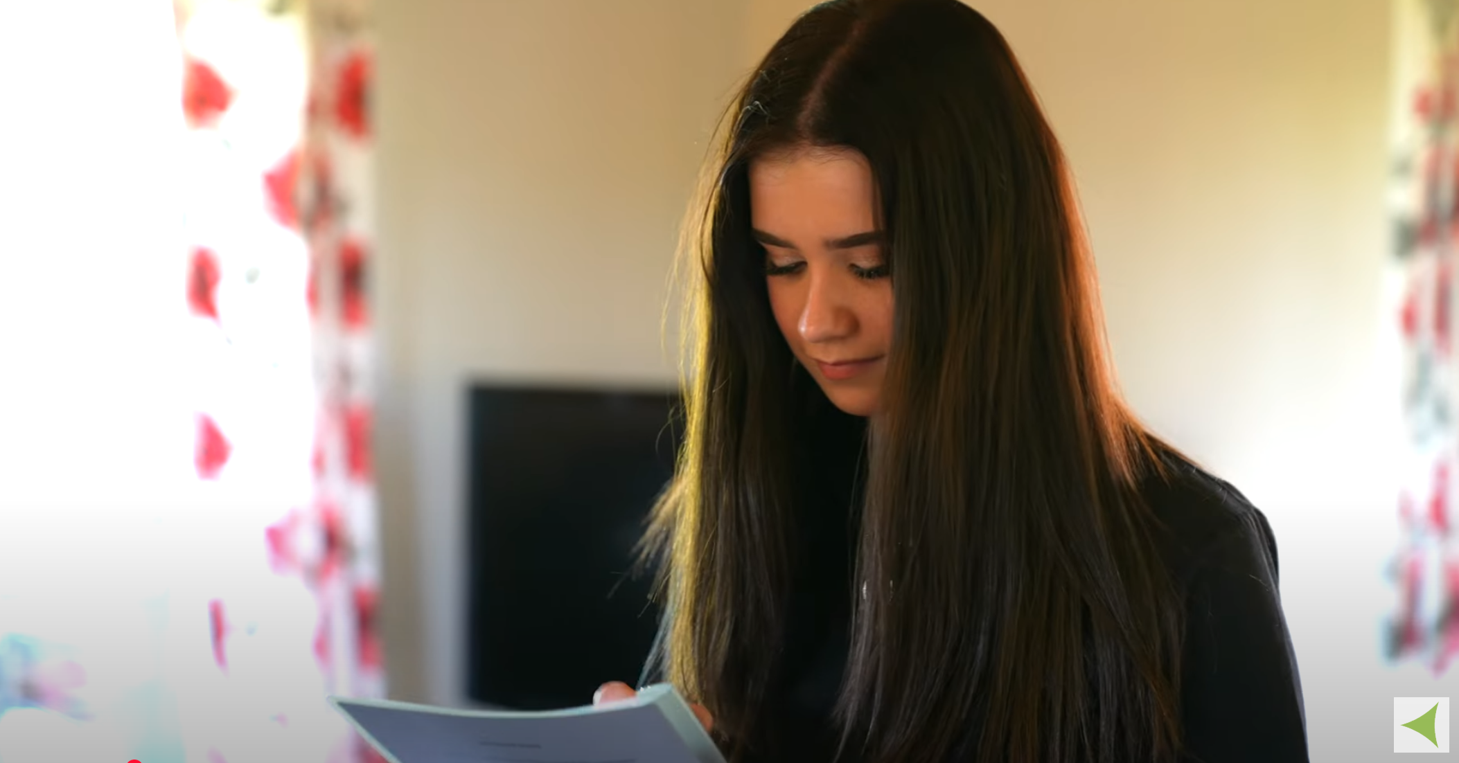 A student looking at a piece of paper.