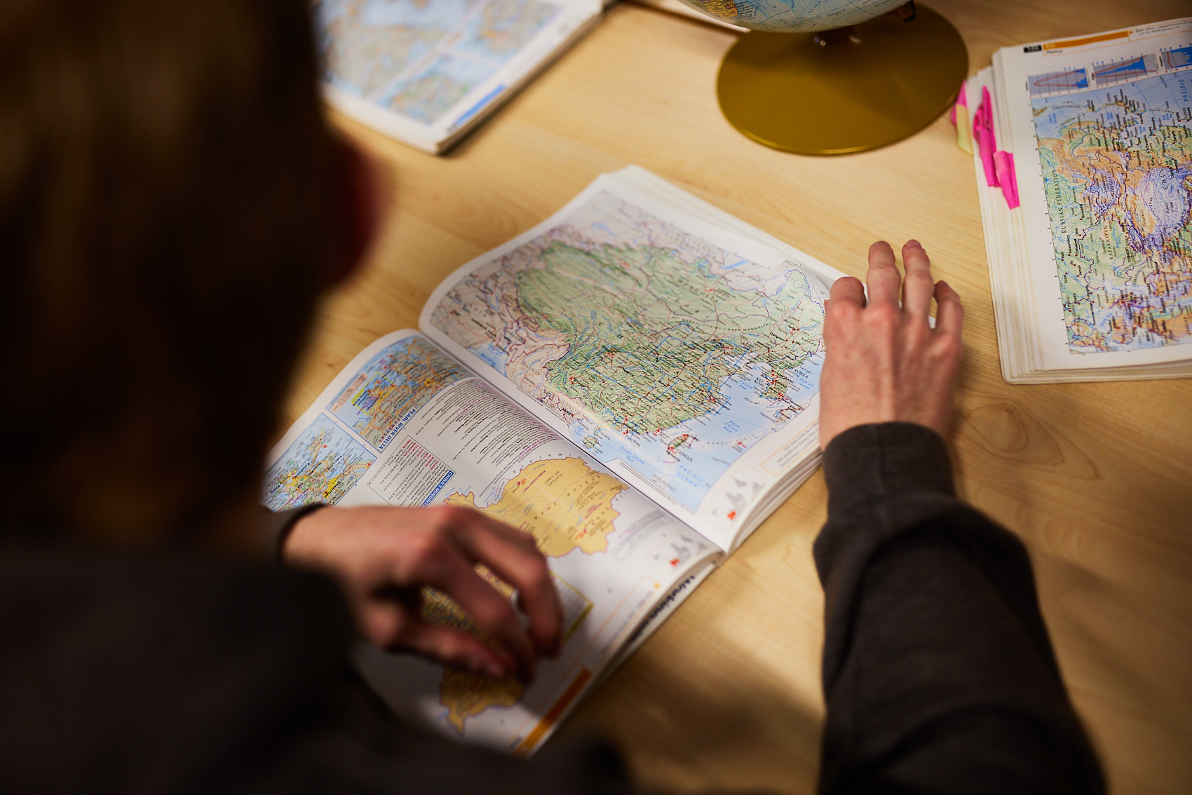 Student observing a map book.