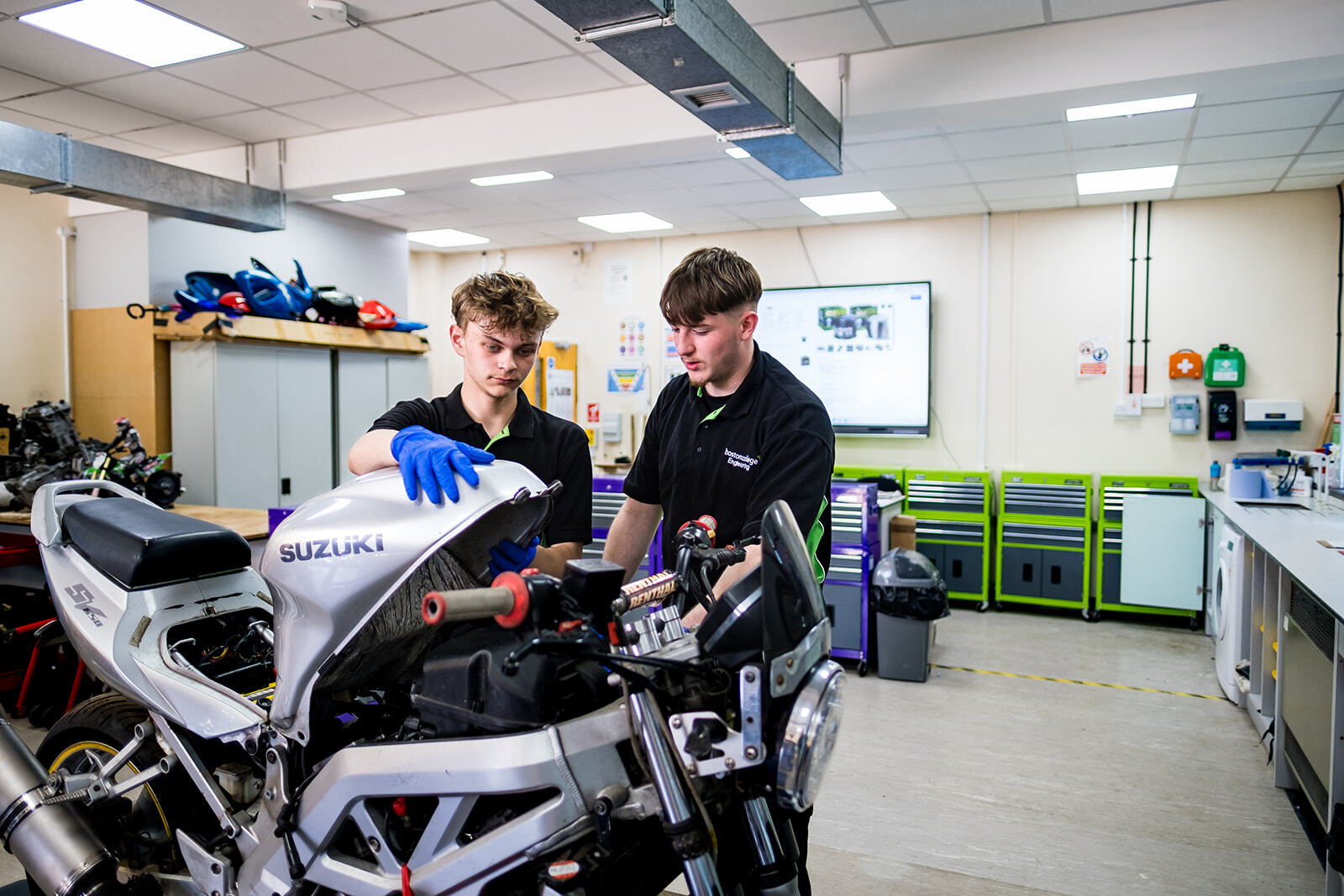 Two students working on a Motorcycle in the Motorcycle Engineering workshop.
