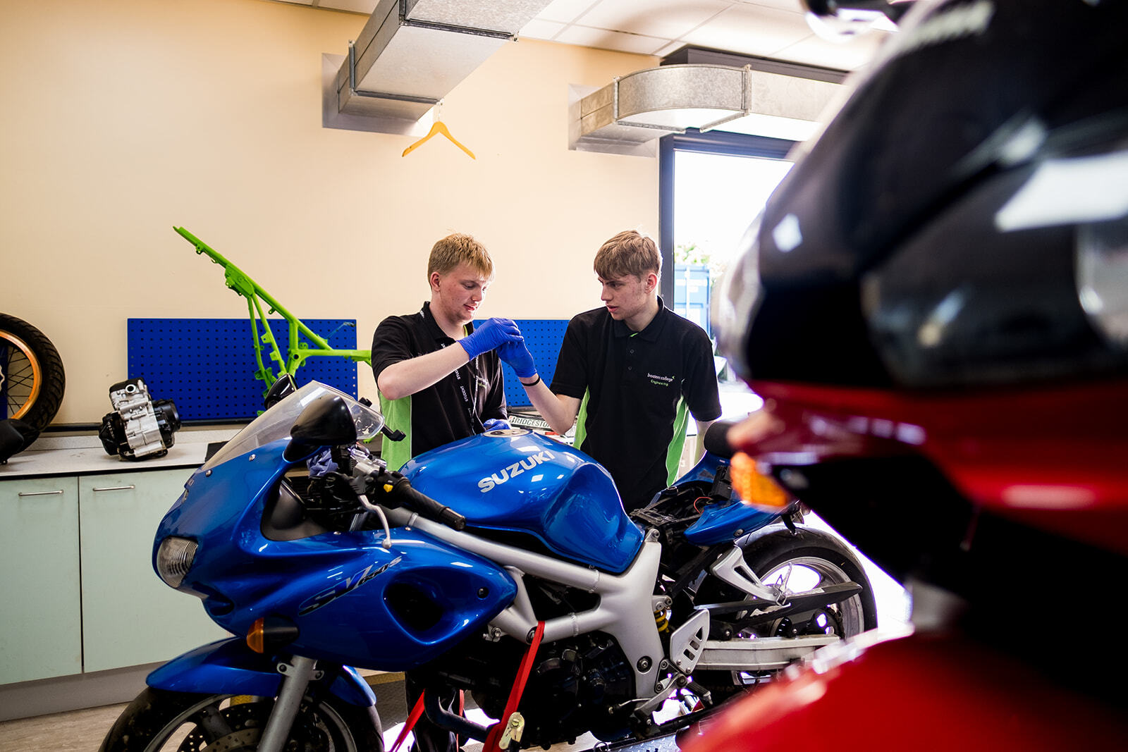Students working on a Motorcycle in the Motorcycle Engineering workshop.