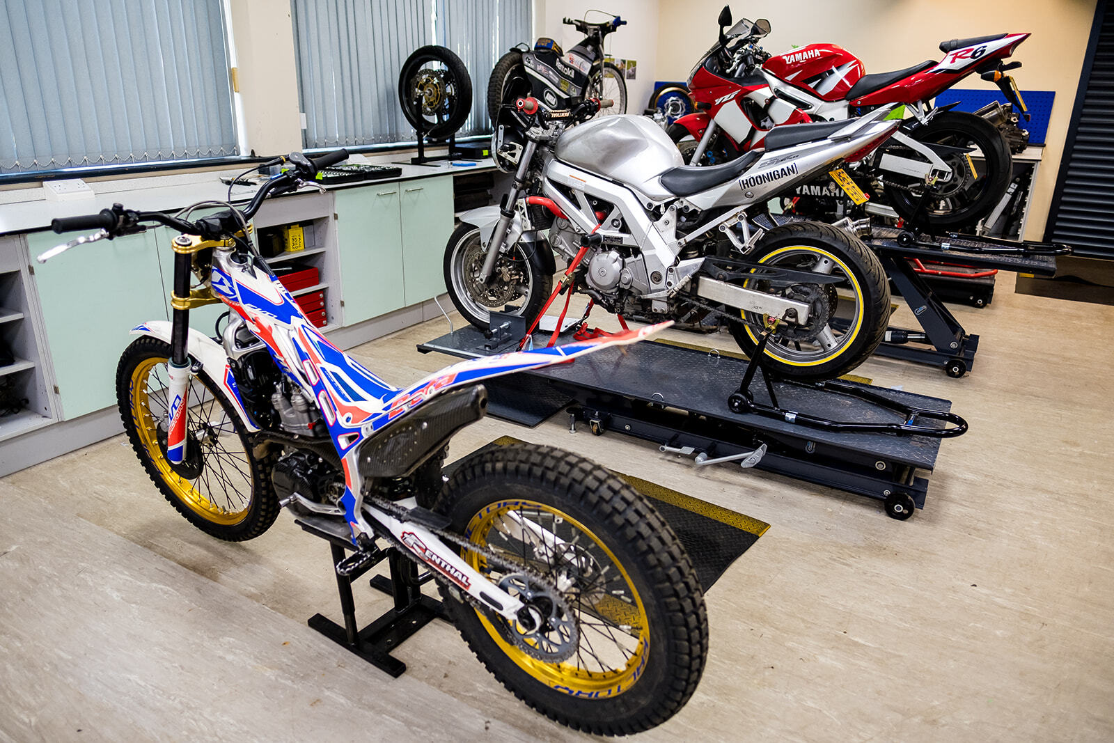Motorcycles lined up in the Motorcycle workshop.