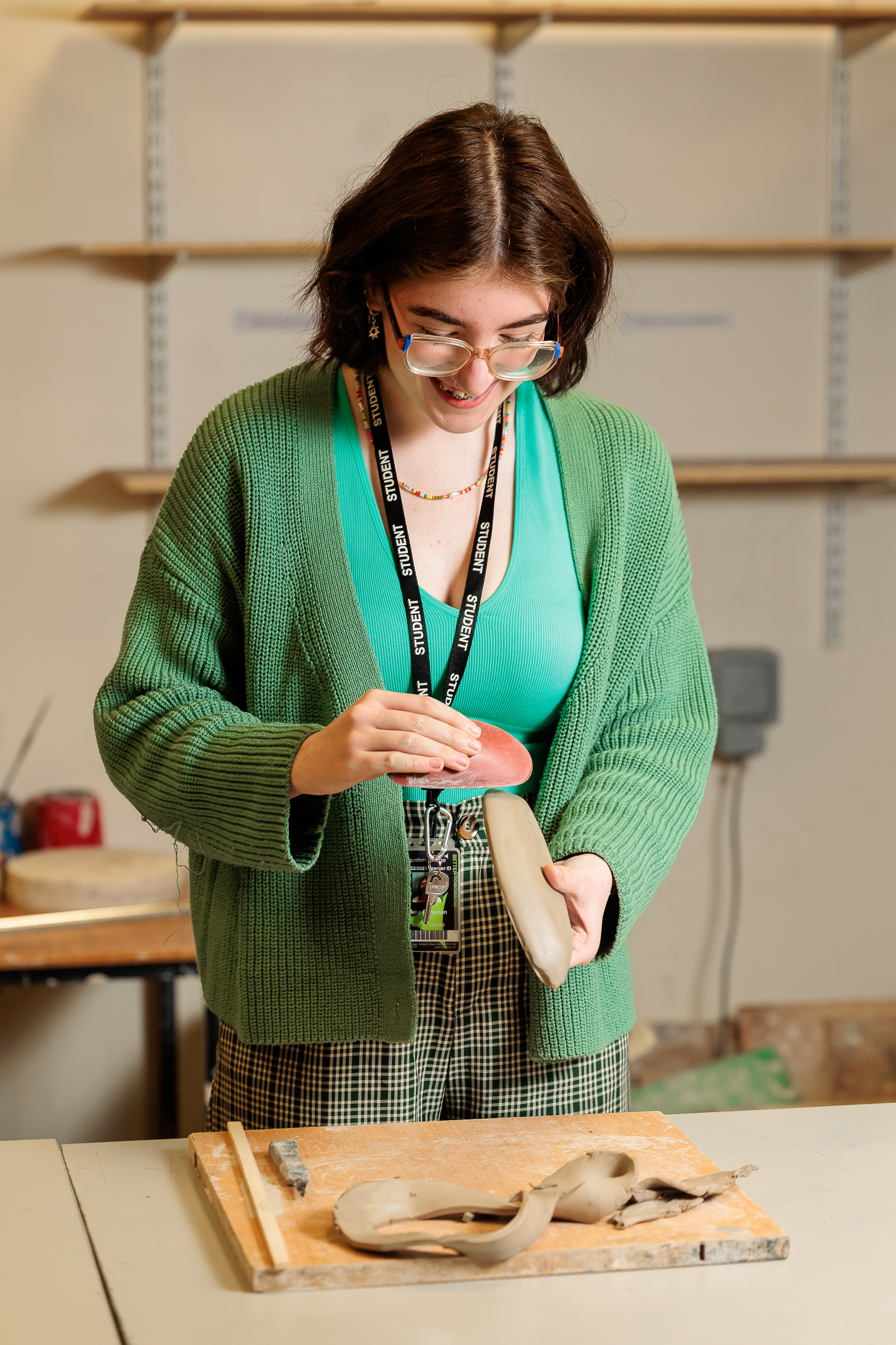 Student shaping modelling clay.