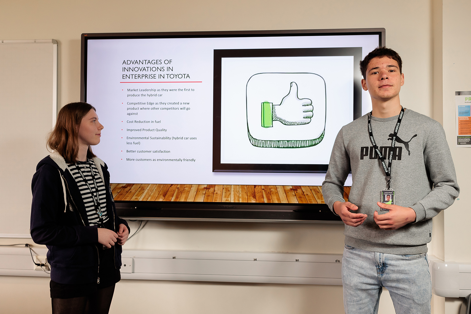 Two students completing a presentation.