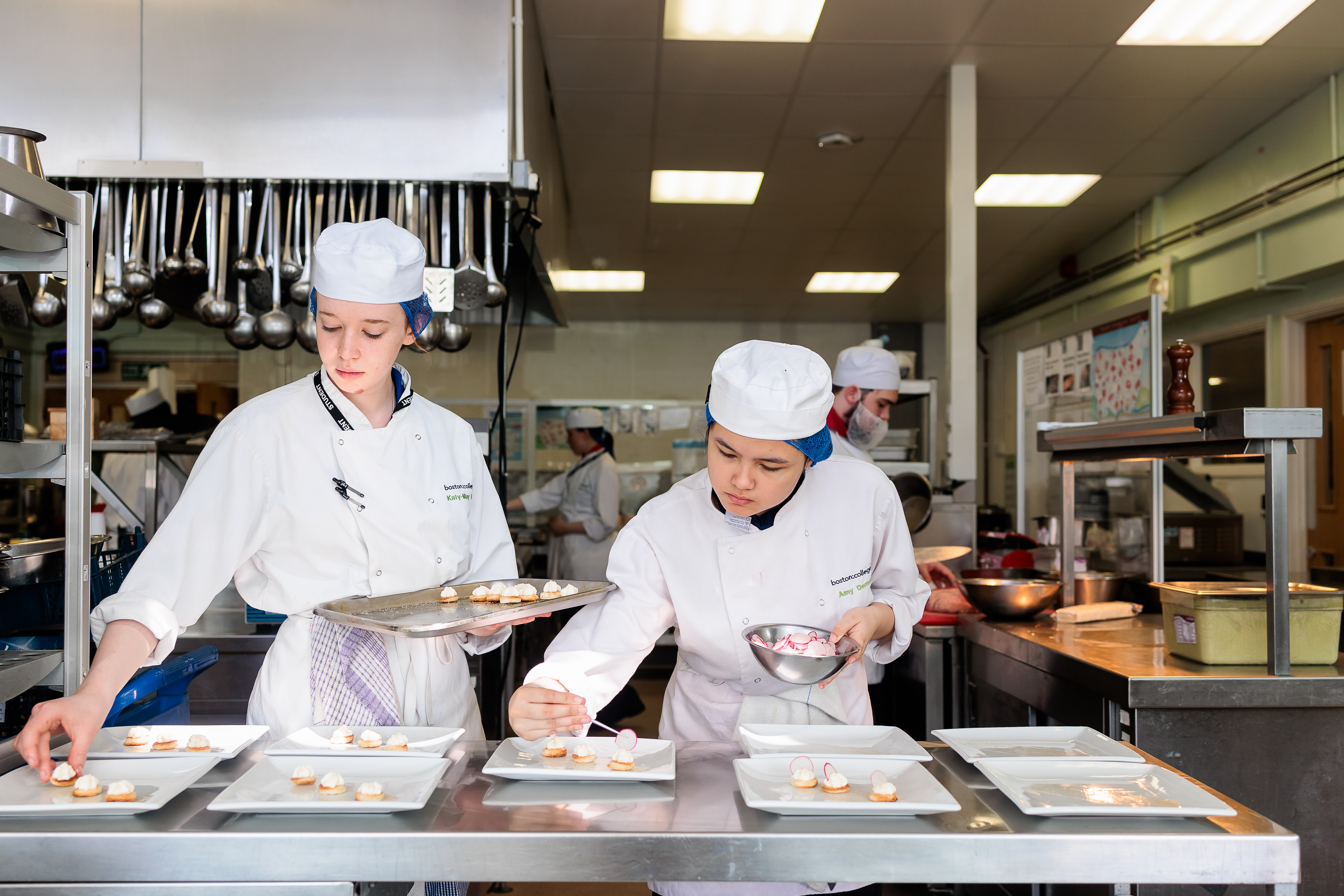 Two student chefs preparing food.