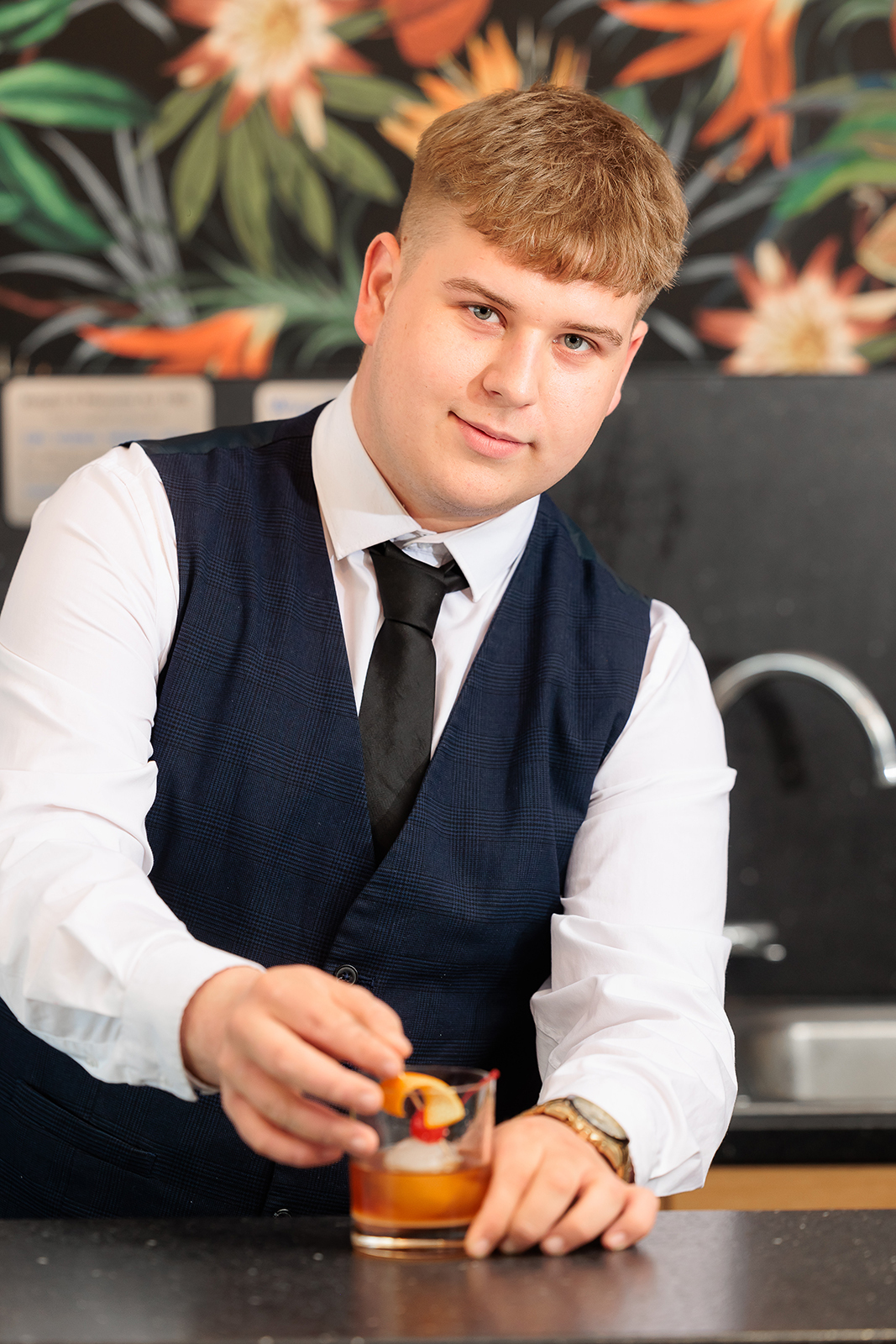 Student making a cocktail.