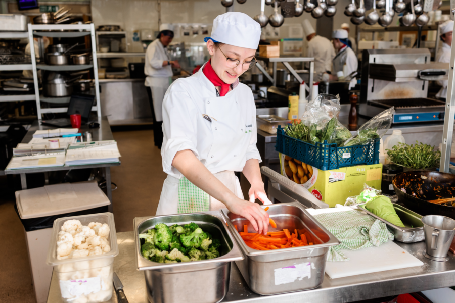 Student chef preparing food.