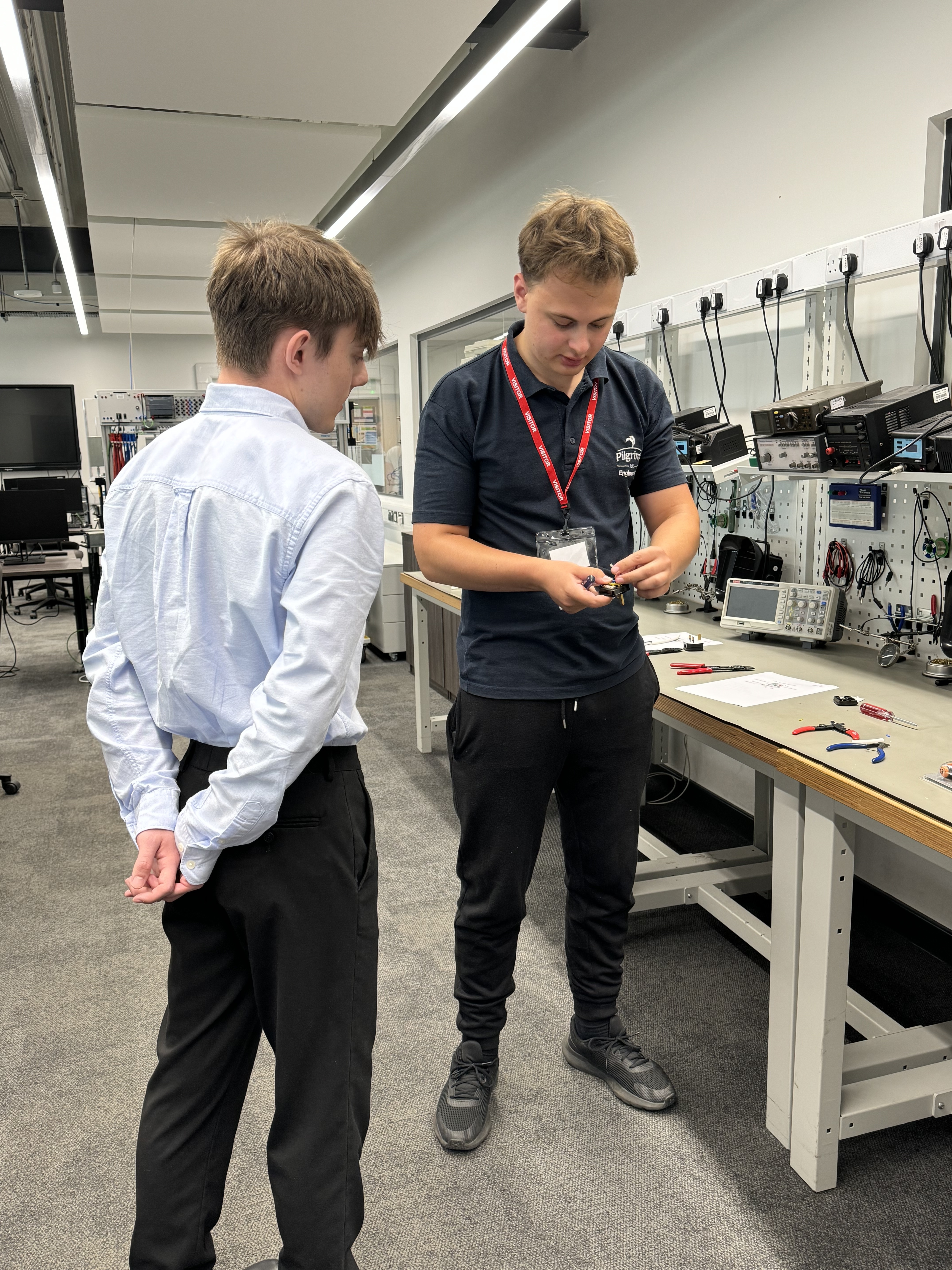 Two people investigating some engineering equipment.