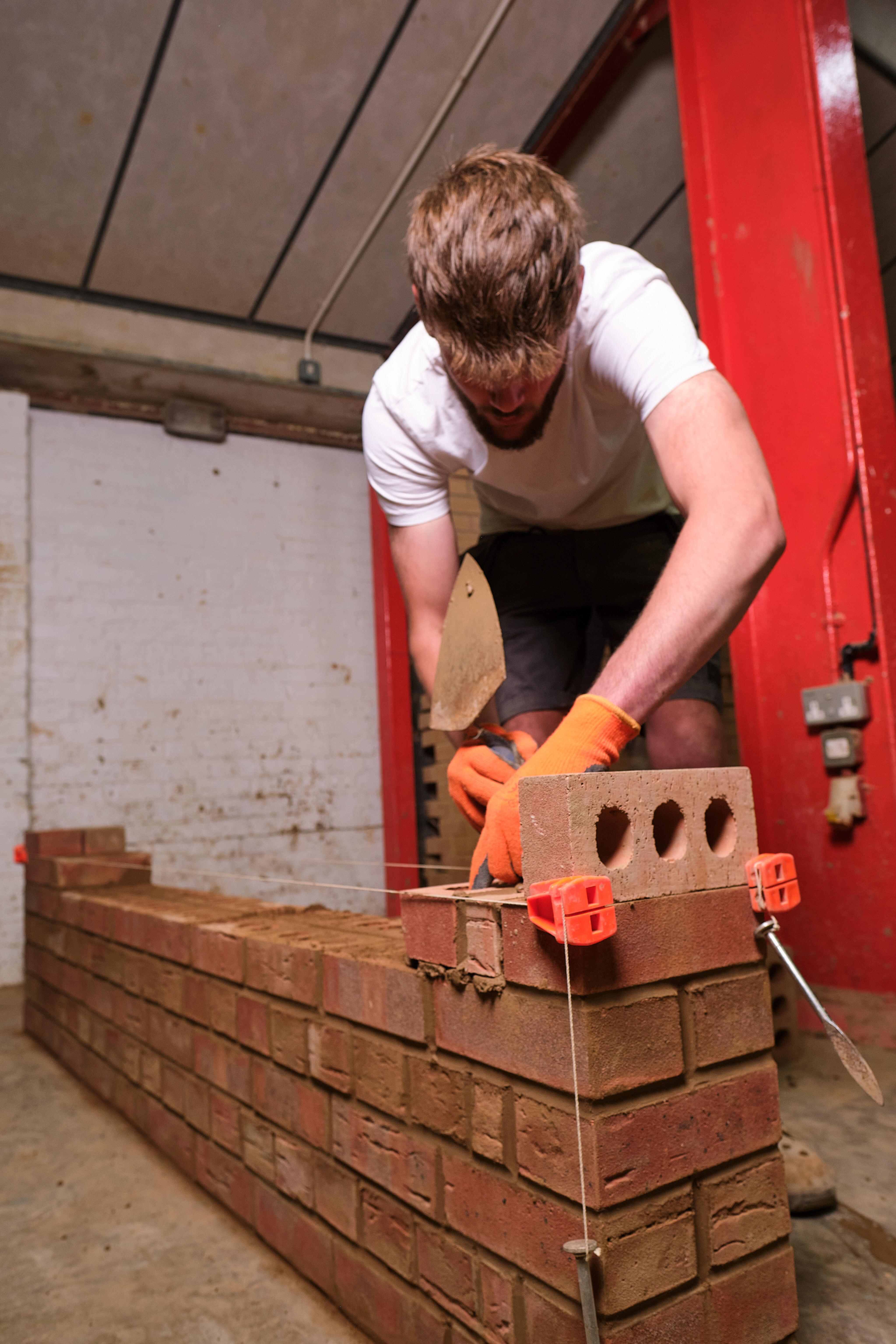 A student building a brick wall.