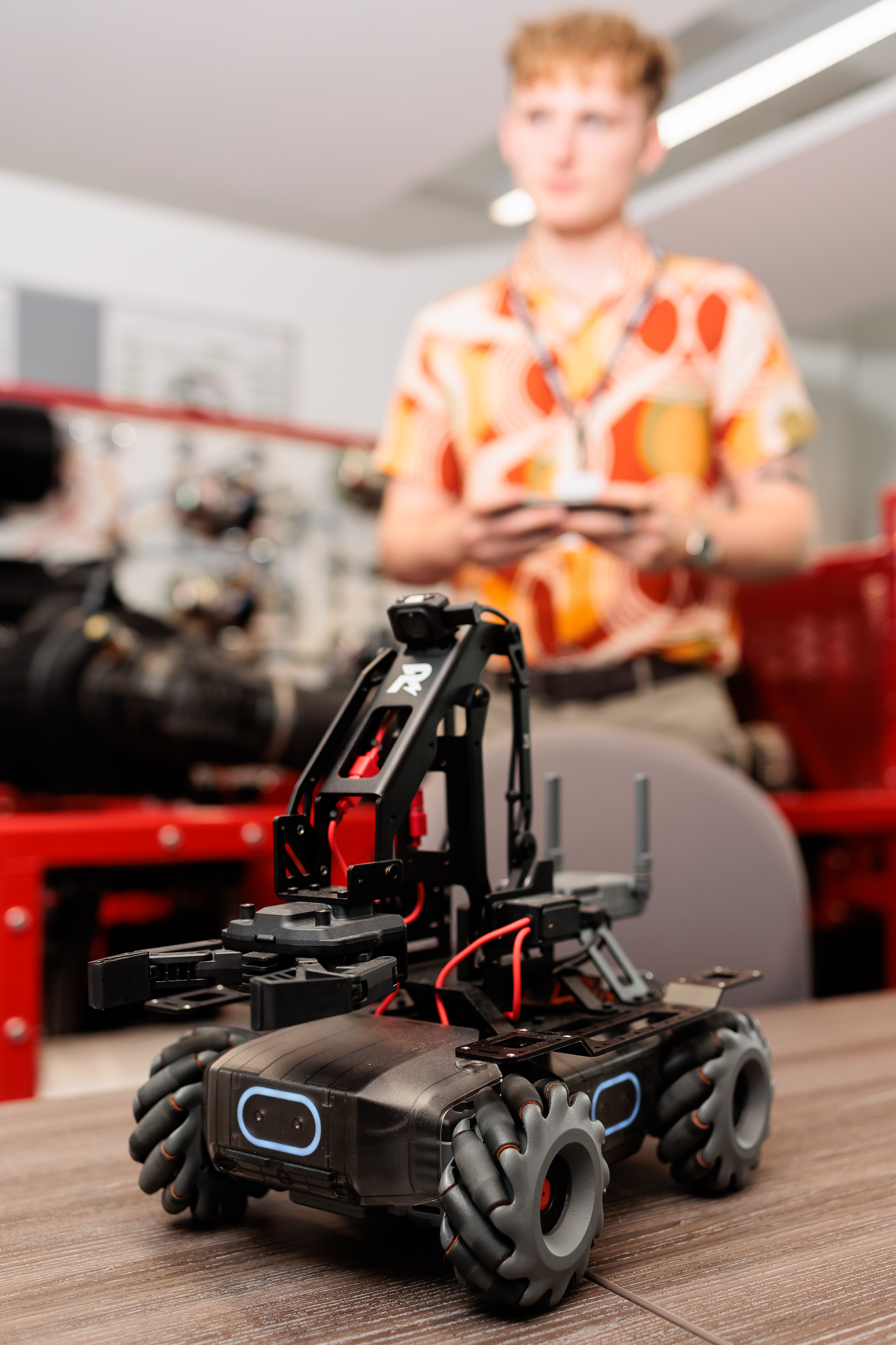 A student controlling a remote controlled vehicle.