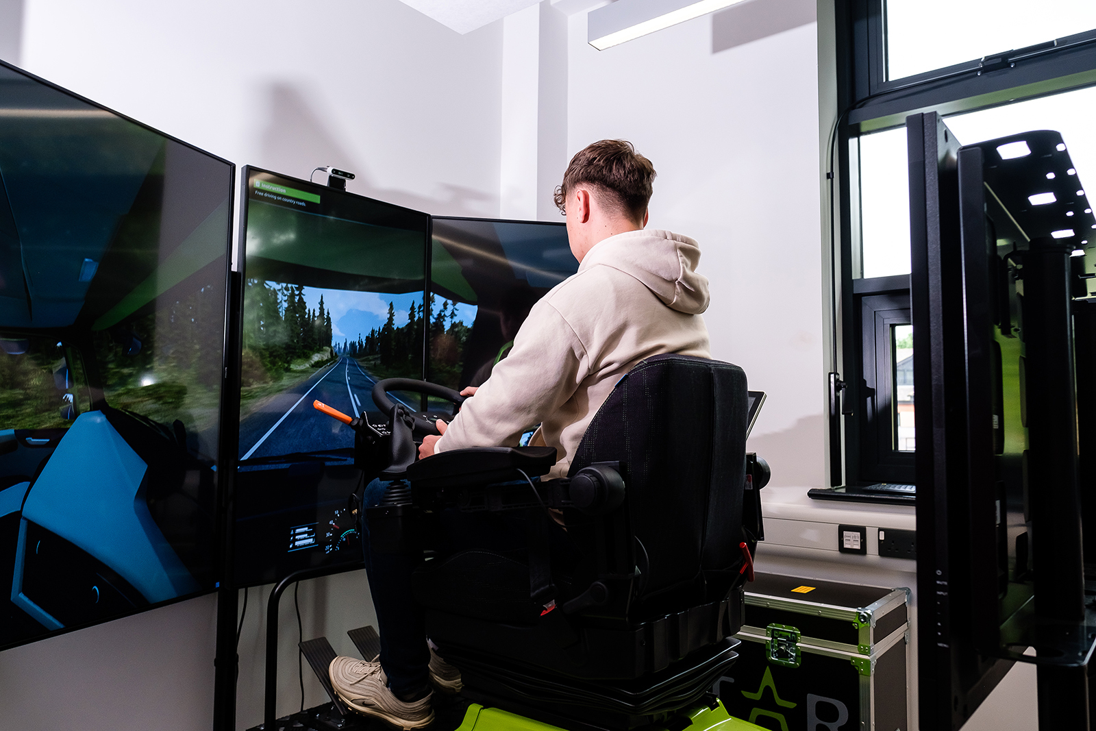 A student using a virtual reality driving simulator.