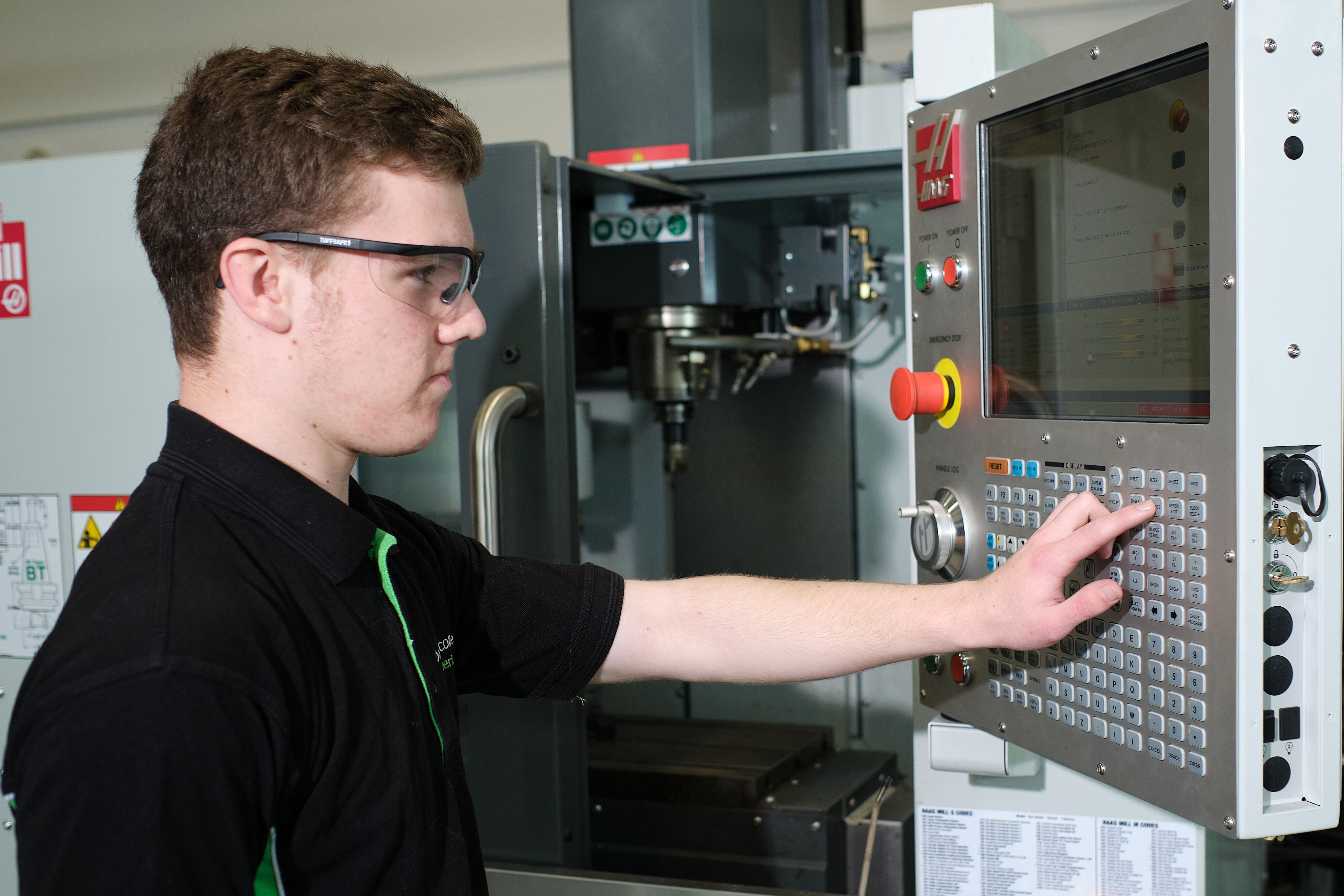 Engineering student works a machine in the workshop.