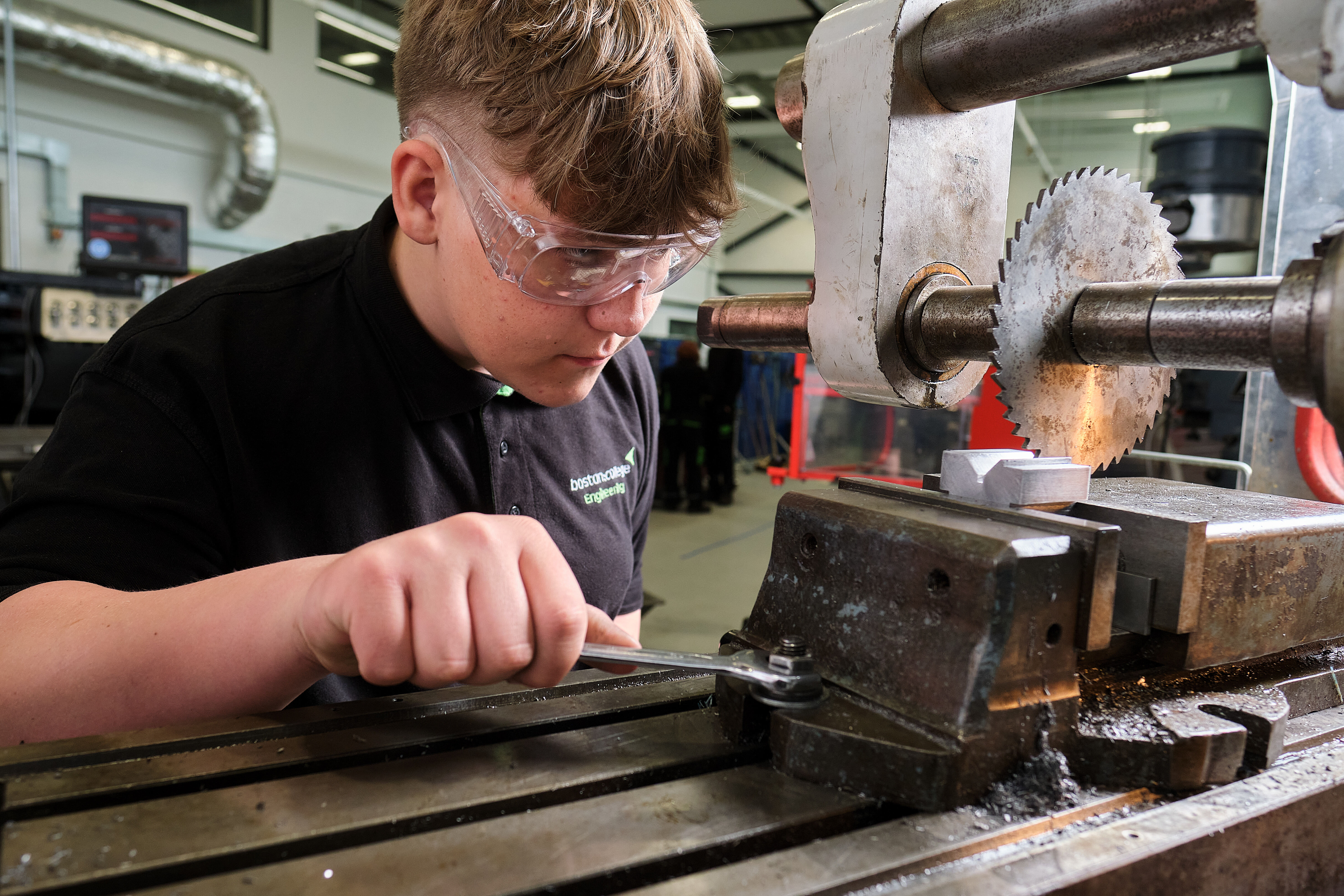 Engineering student works a machine in the workshop.