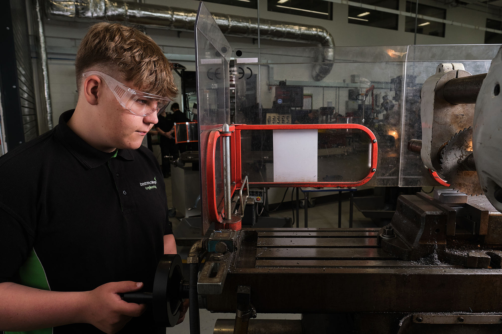 Engineering student works a machine in the workshop.