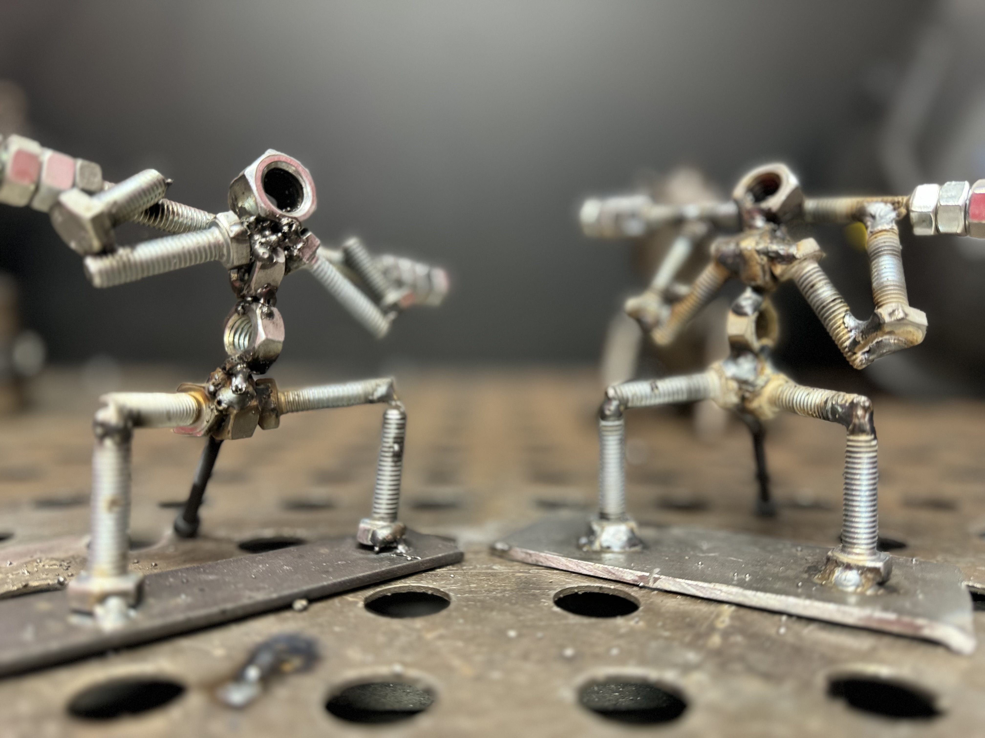 Pair of welded figurines using nuts, bolts and screws.