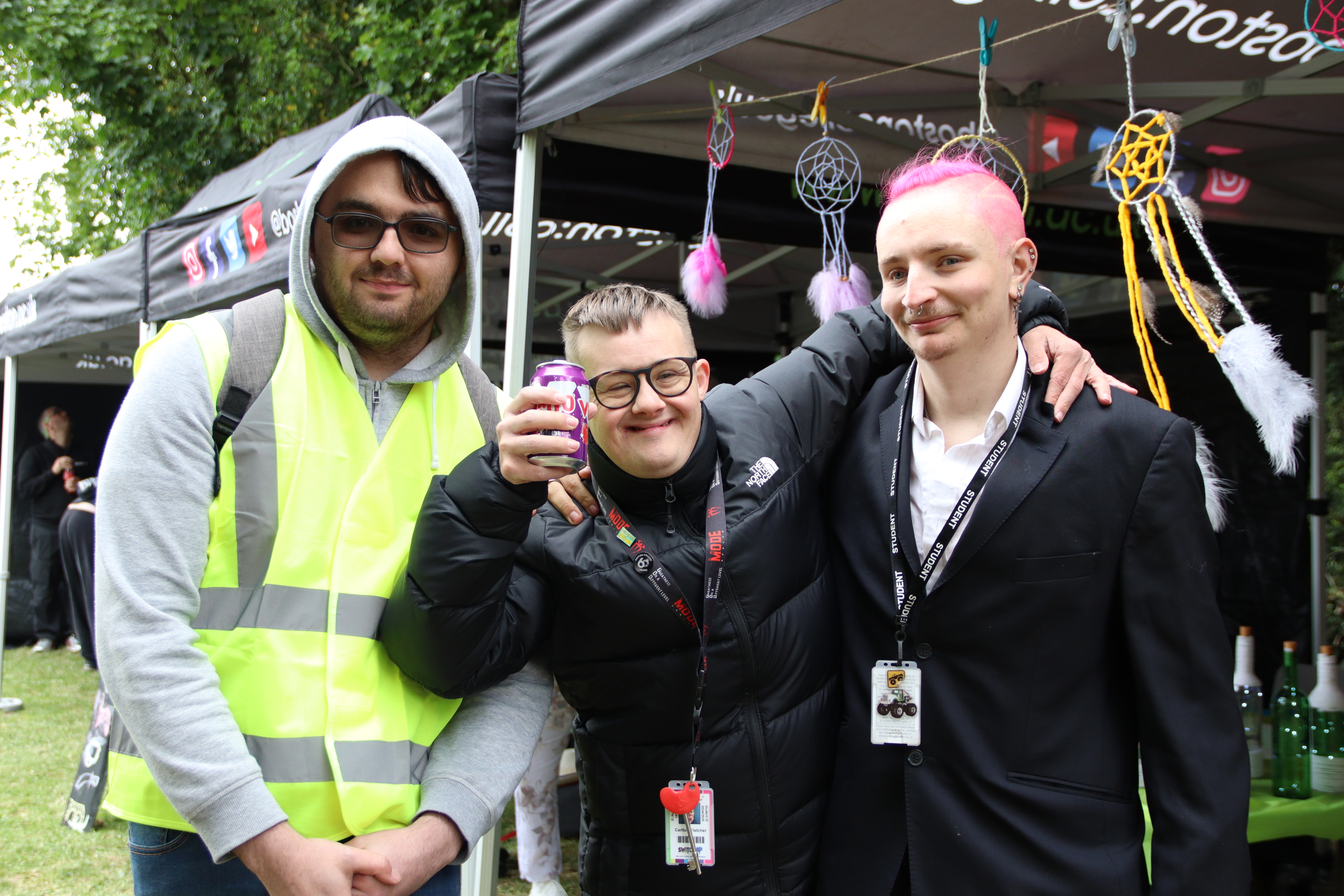 Three students photographed together at an event.