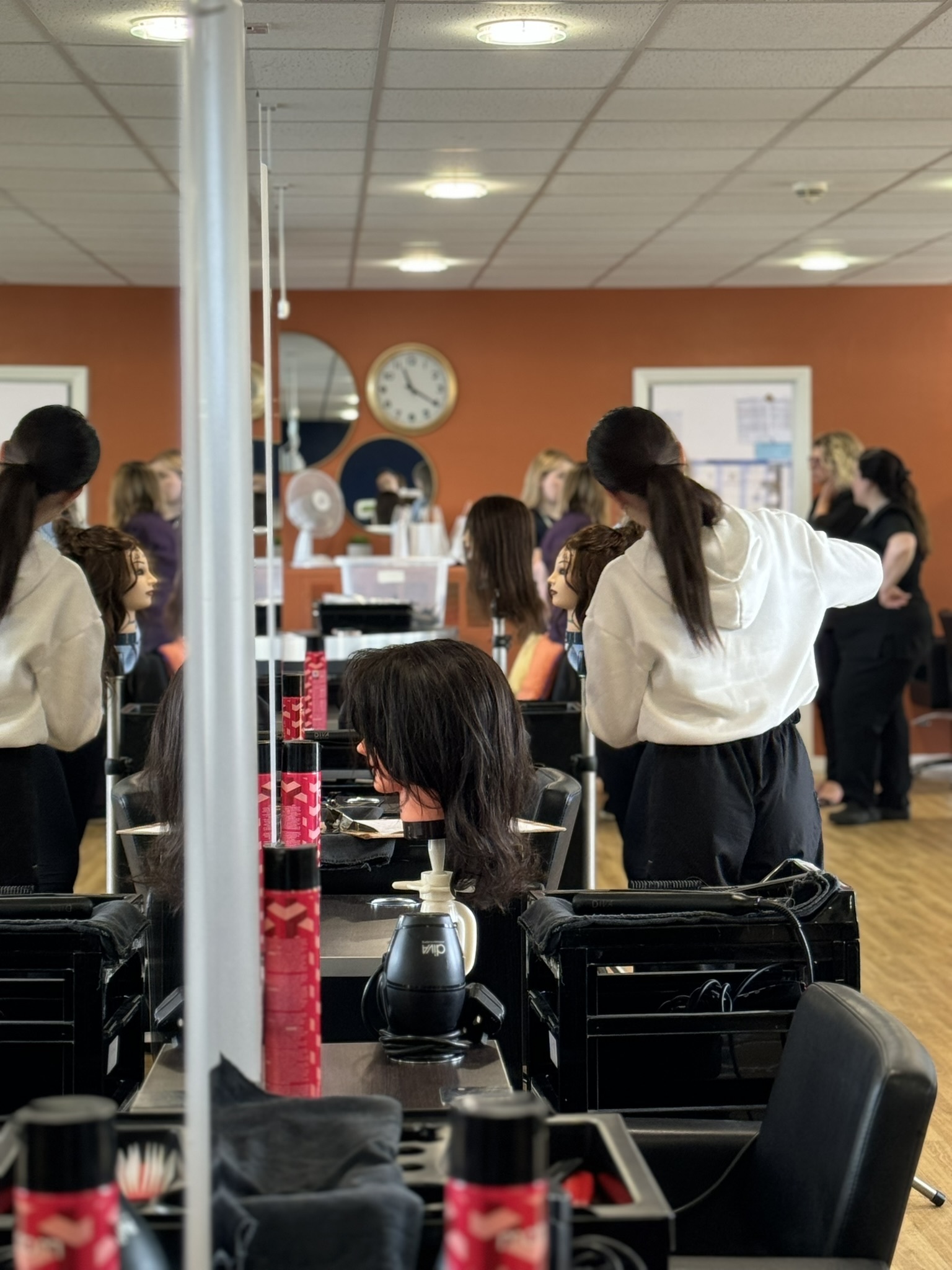 A student cutting hair in the salon.