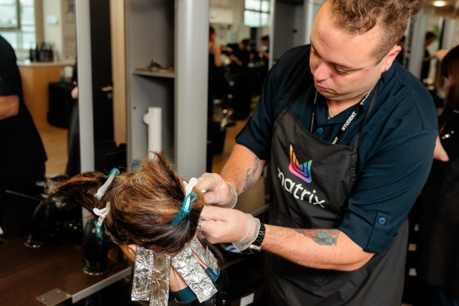 A student cutting hair in the salon.