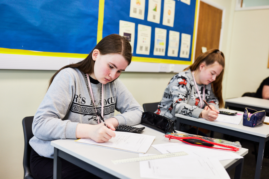 Two students sitting a Maths exam.