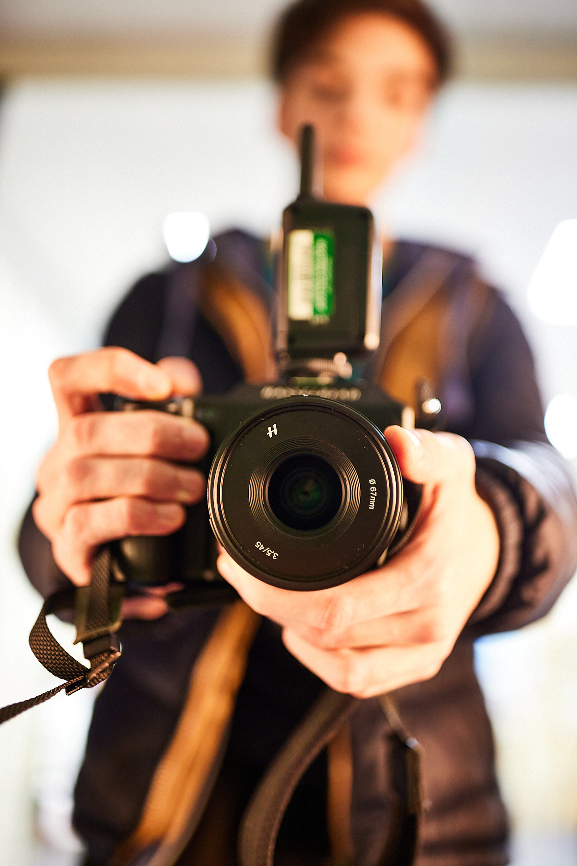 A student pointing a camera towards the screen.