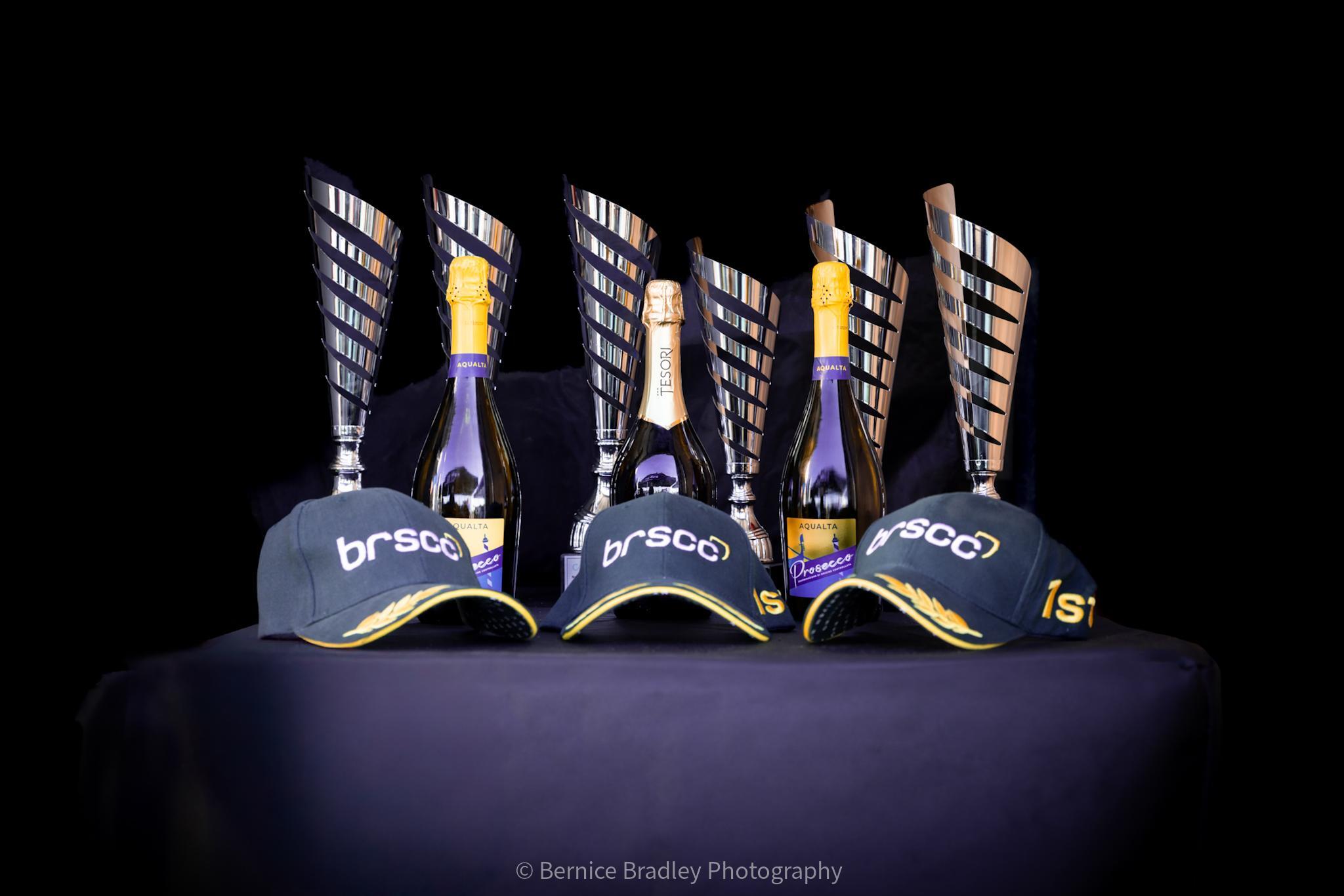Boston College Racing trophies and caps display.