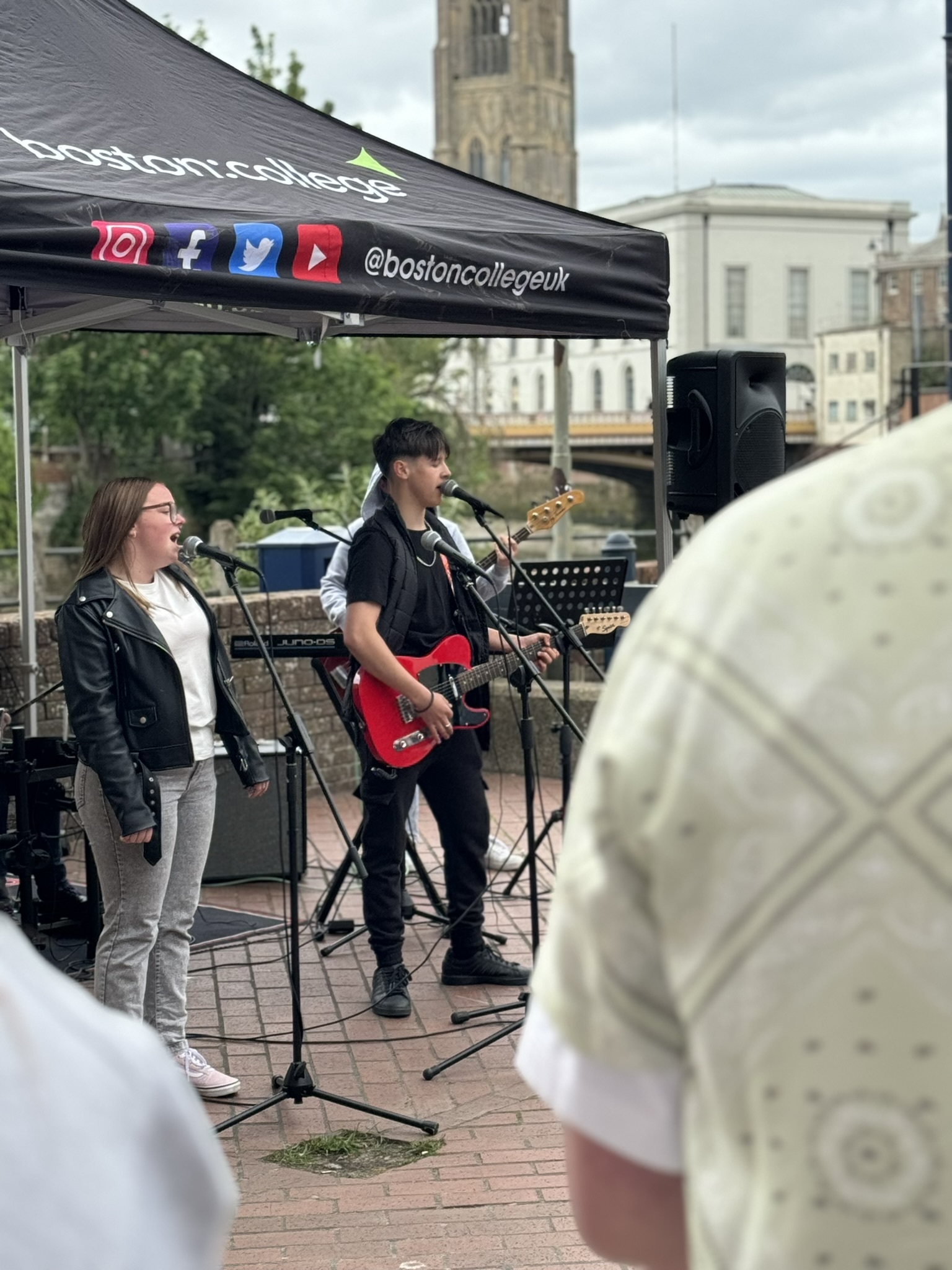 A student band performing on the street under a Boston College gazebo.