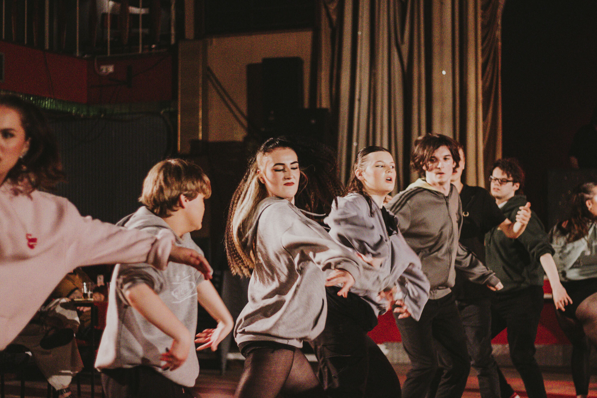 A group of student dancers performing in a line.