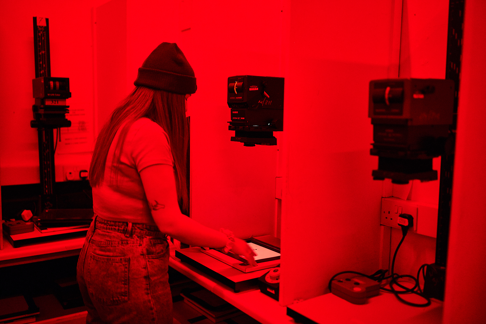 A student working in a photographic darkroom.