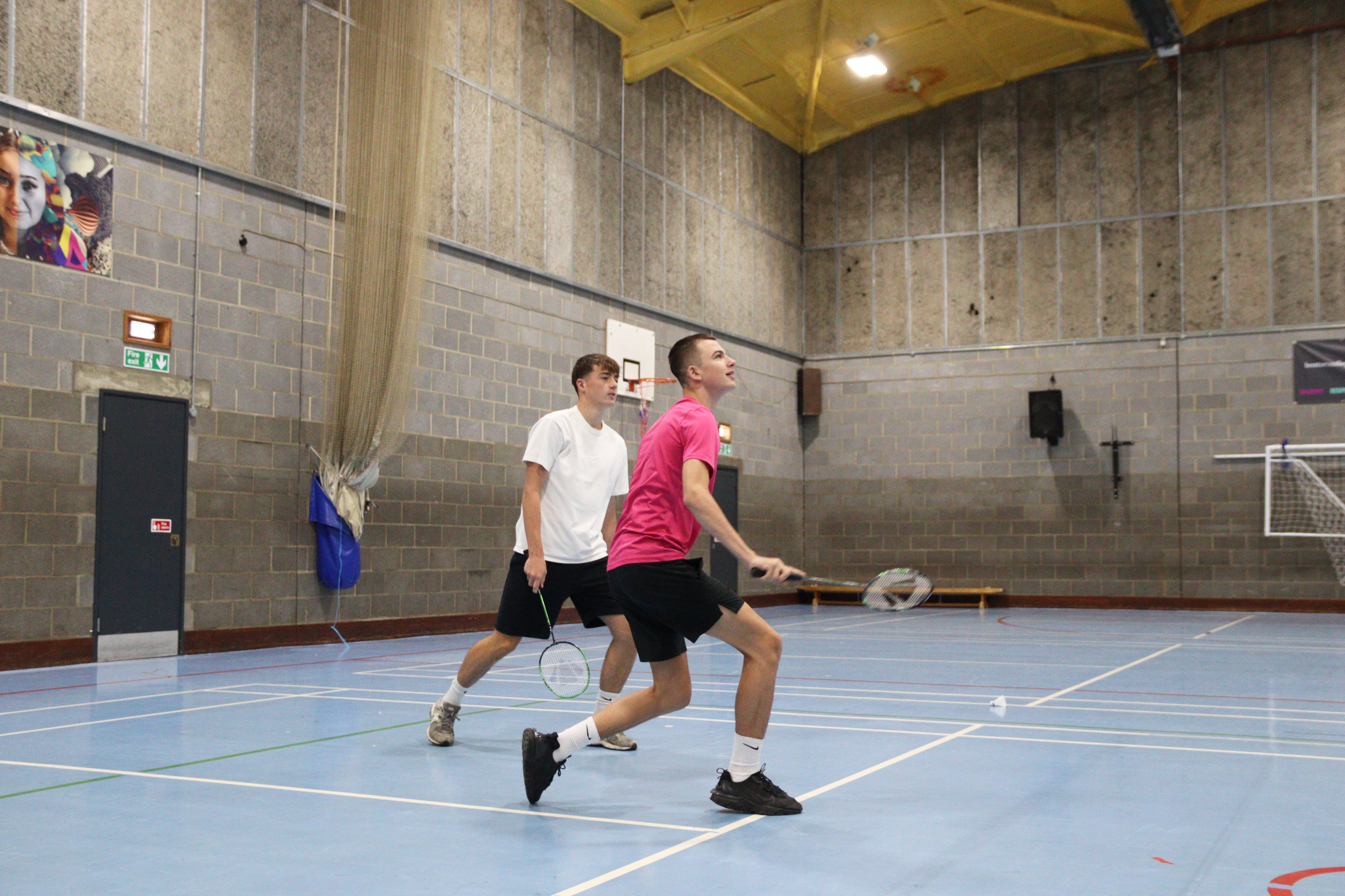 Two students playing Badminton.