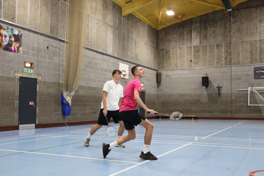 Two students playing Badminton.