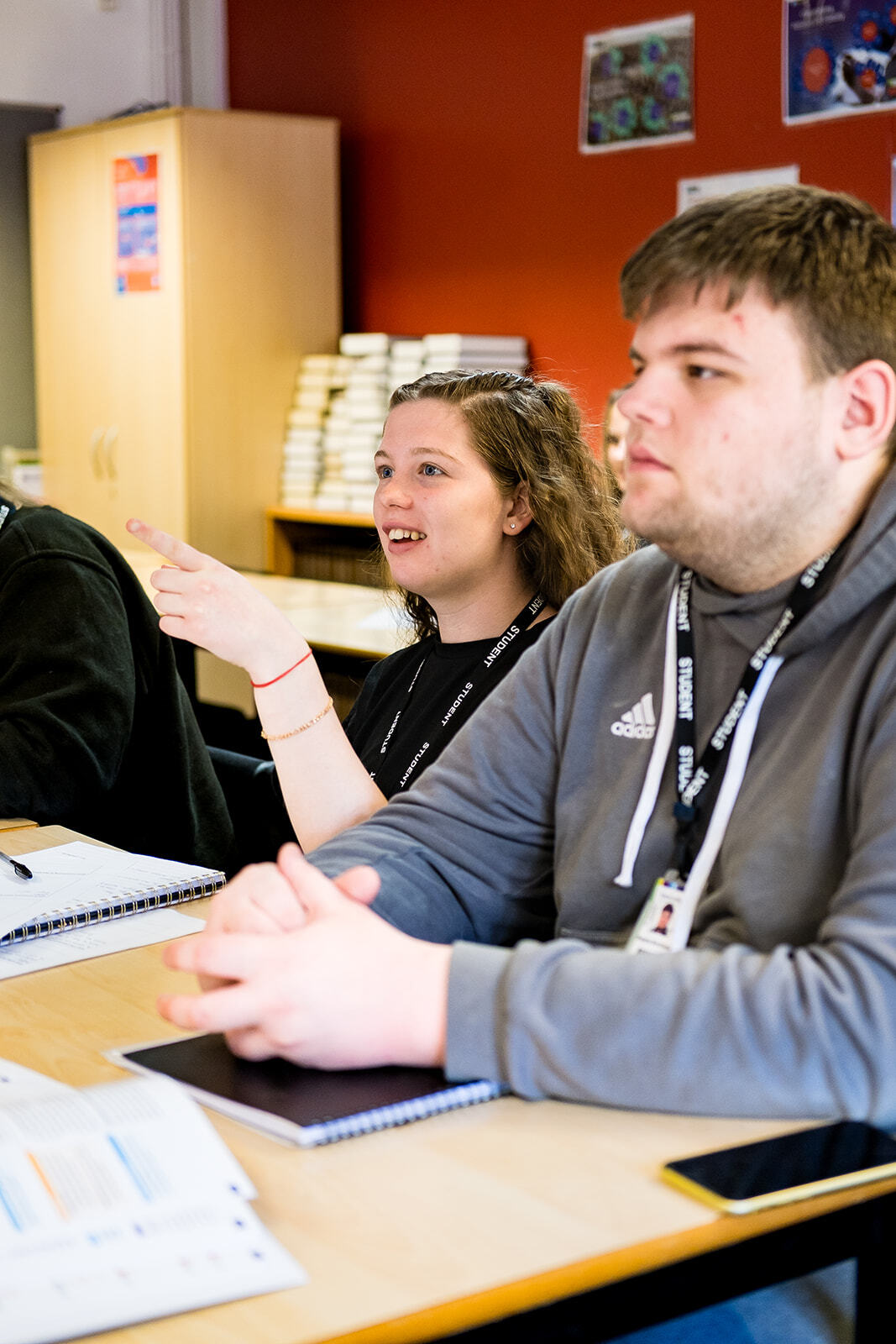 Two students looking forward engage with a lesson.