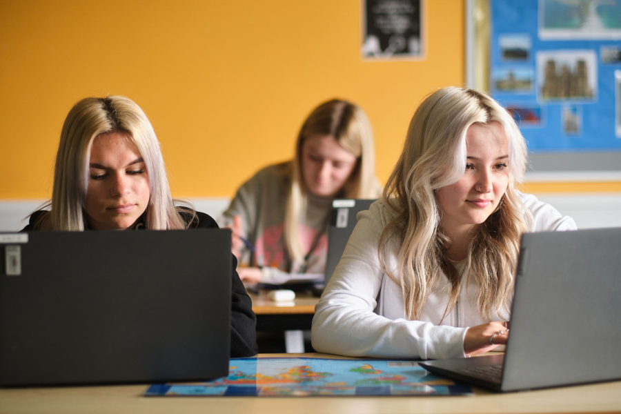 Students working at their laptops.