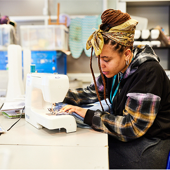 A student using a sewing machine.