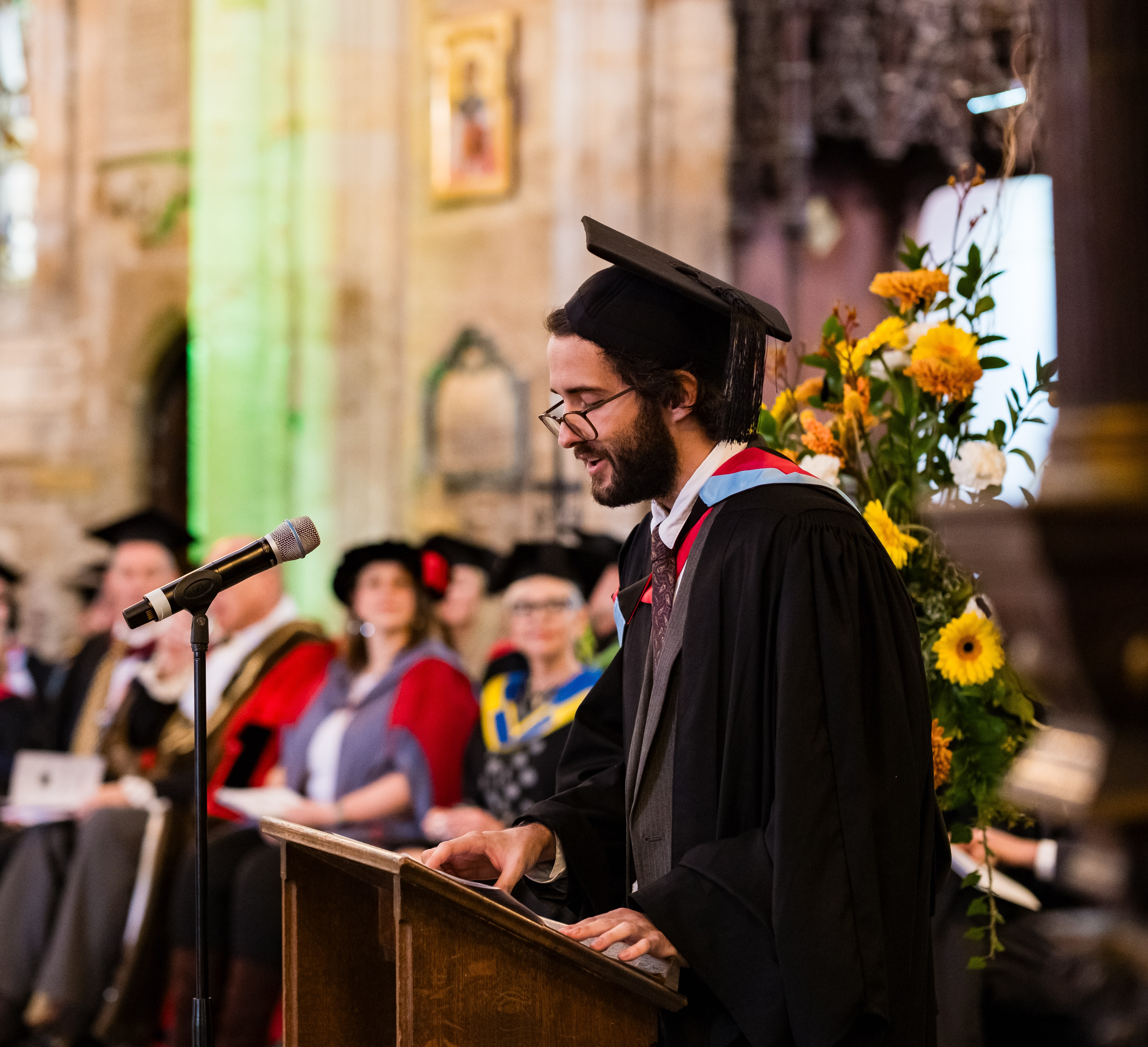Image from Boston College Graduation 2025 - student speaker Keegan delivering his speech on stage