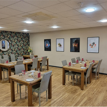A restaurant with set tables.