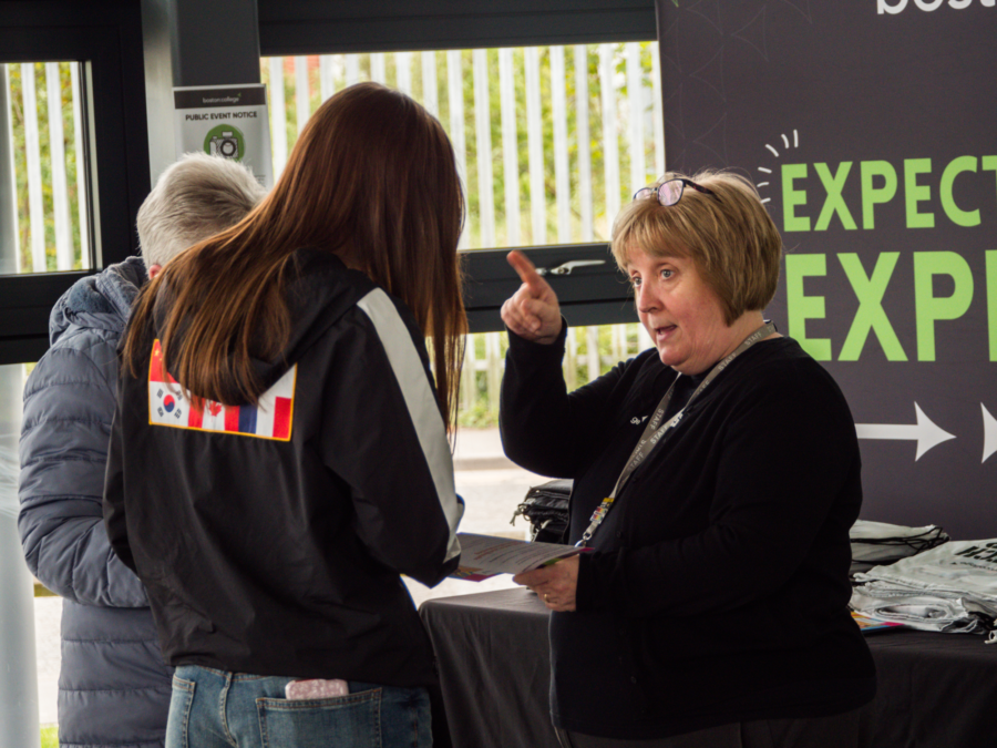 Staff give visitors directions at an open event.