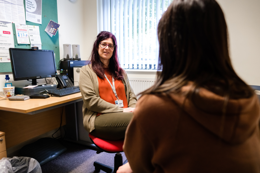 Boston College Counsellor talking to a student who has their back to the camera