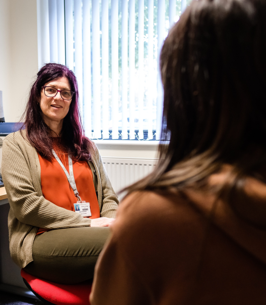 Boston College Counsellor talking to a student who has their back to the camera