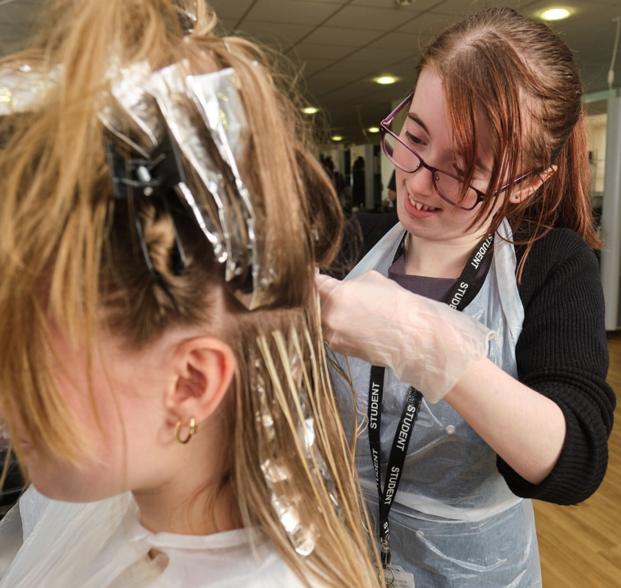A student cutting hair.
