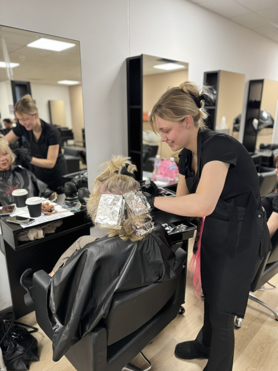 a student colouring hair.
