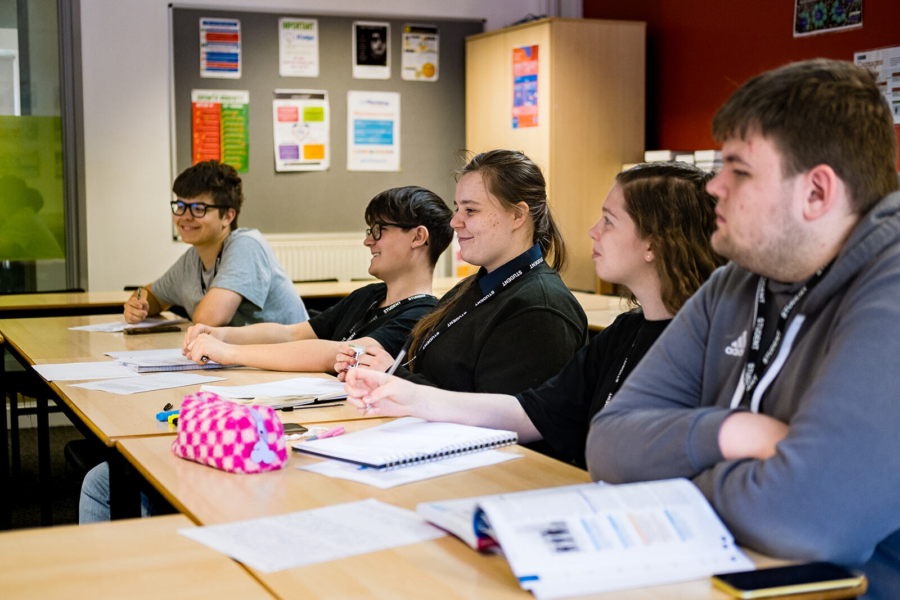 A group of students listening in on a lesson.