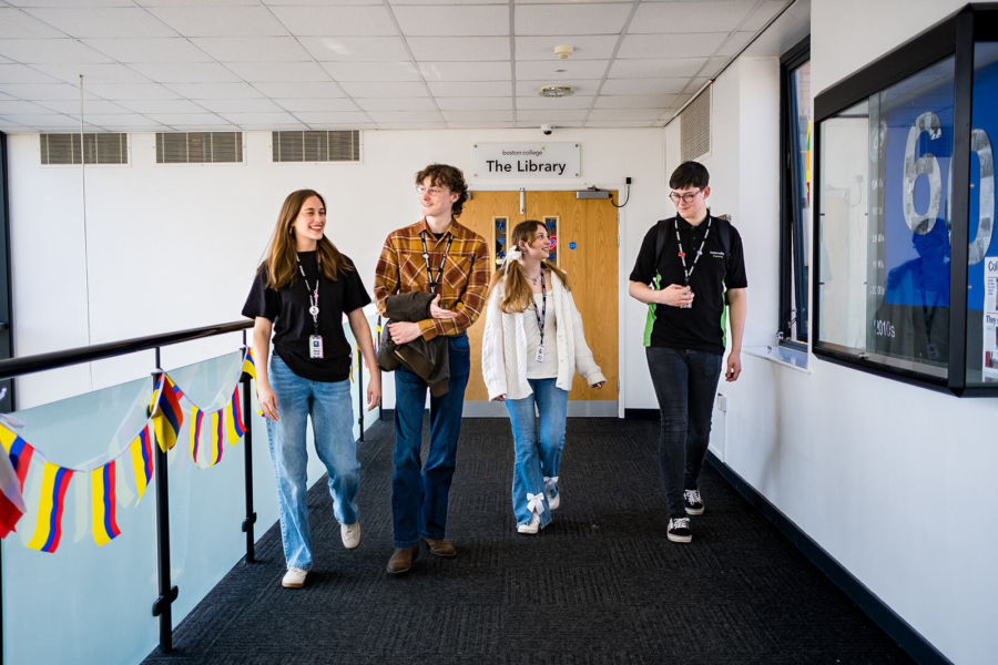 Four students walking together down a corridor.