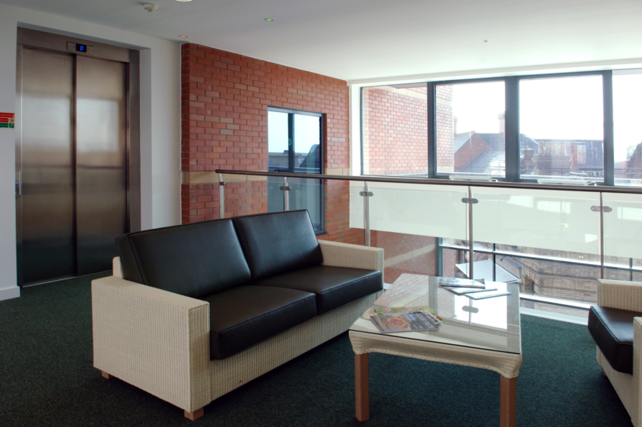 A communal area at Spalding campus with a lift and chairs.